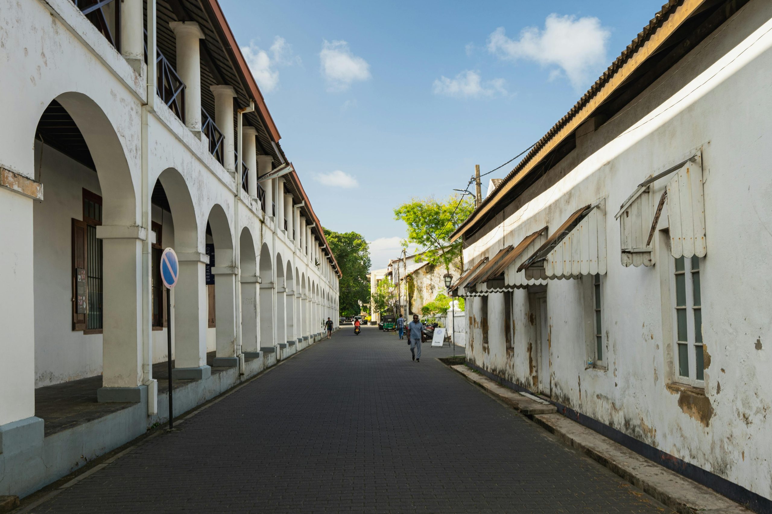 Charming view of a historic street in Galle Fort, Sri Lanka, showcasing colonial architecture and a serene urban environment.