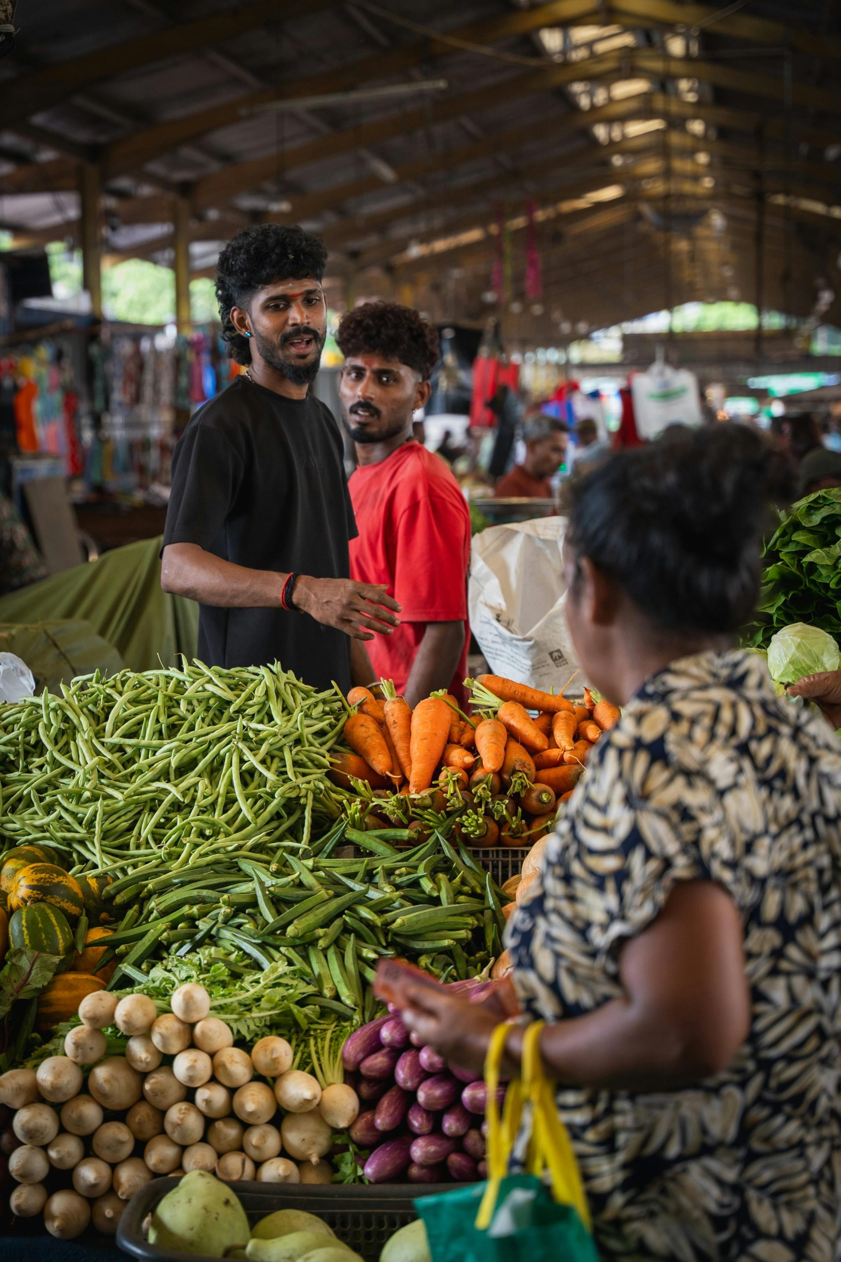 Colorful vegetable market in Colombo, Sri Lanka with local vendors and shoppers.